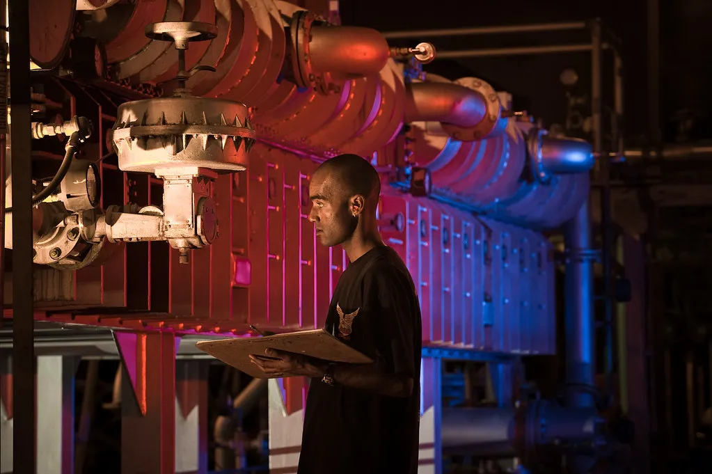 An operator at a plant control panel